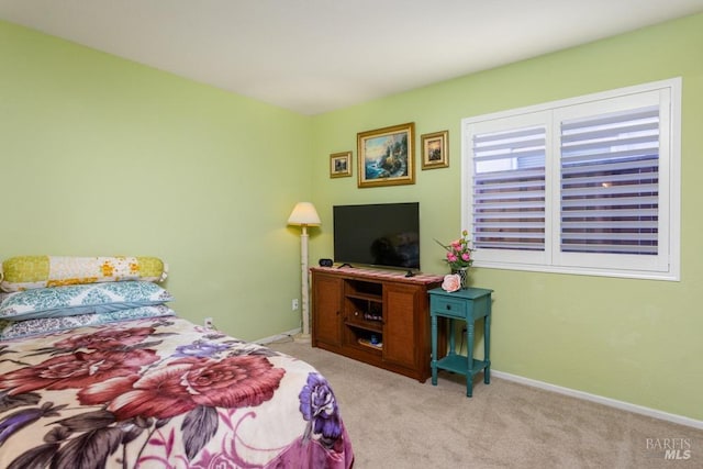 bedroom featuring light carpet