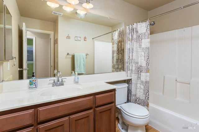 full bathroom with vanity, shower / bath combination with curtain, and toilet