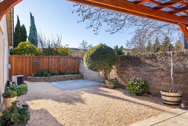 view of yard featuring a pergola, central AC, and a patio