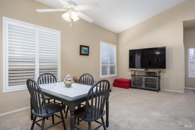 carpeted dining area featuring lofted ceiling and ceiling fan