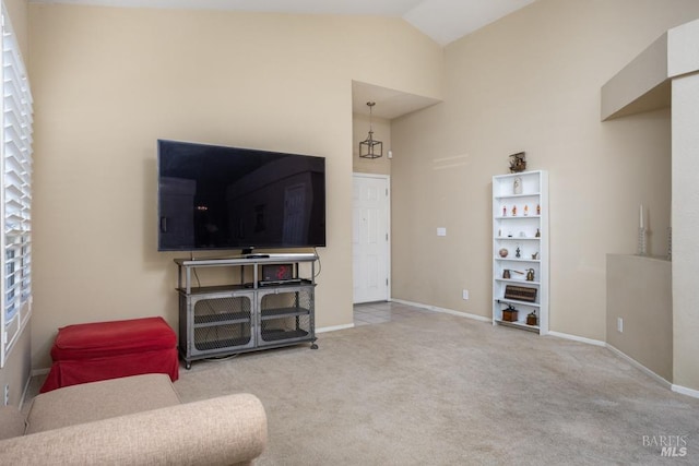 living room featuring vaulted ceiling and carpet