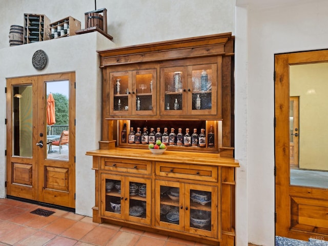 bar with a dry bar and light tile patterned flooring