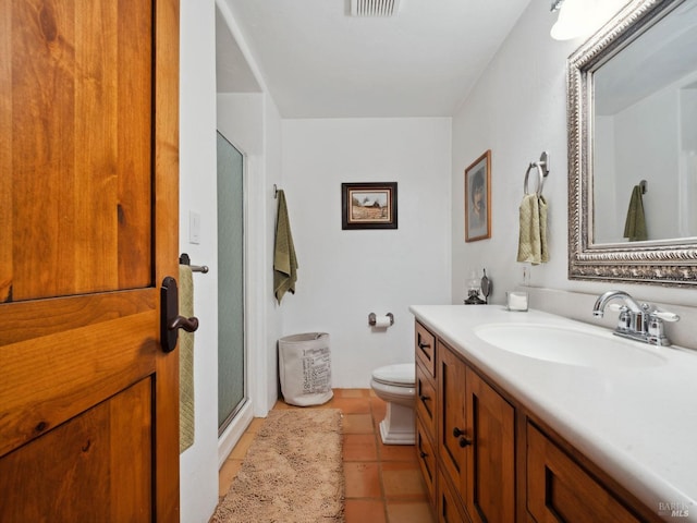 bathroom with toilet, visible vents, vanity, tile patterned floors, and a stall shower