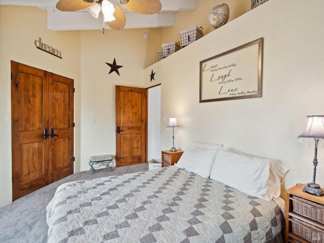 carpeted bedroom featuring high vaulted ceiling and ceiling fan