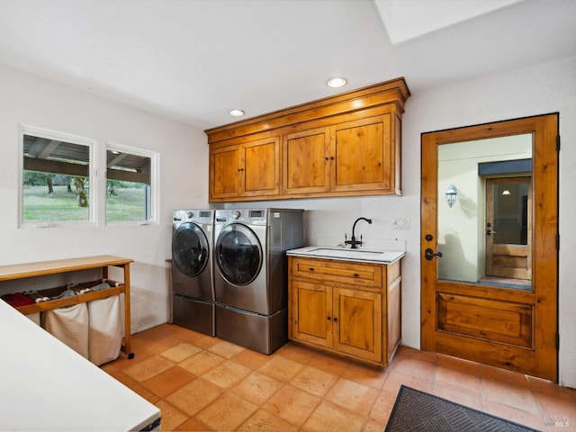 laundry area featuring cabinet space, washing machine and dryer, a sink, and recessed lighting