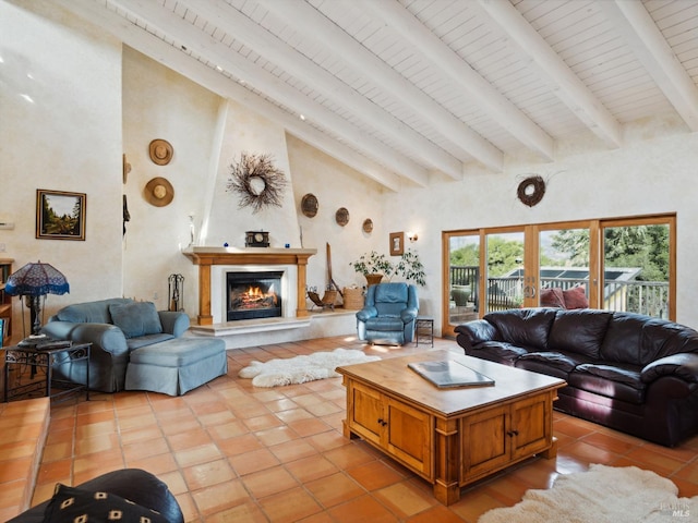 living area with high vaulted ceiling, light tile patterned flooring, a lit fireplace, french doors, and beam ceiling