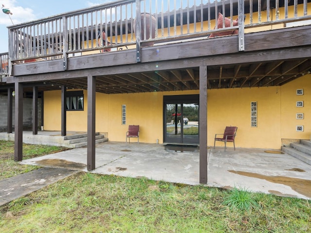 back of property with a patio area, a deck, and stucco siding