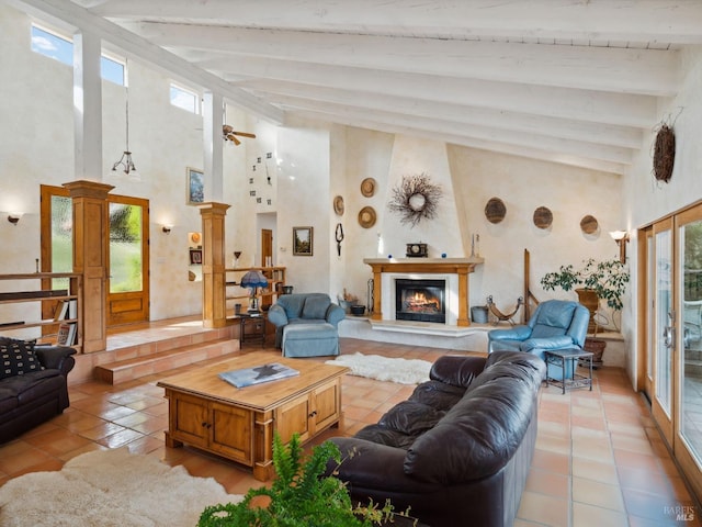 living room featuring a wealth of natural light, a glass covered fireplace, and light tile patterned floors