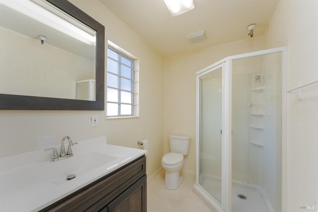 bathroom with vanity, tile patterned flooring, a shower with shower door, and toilet