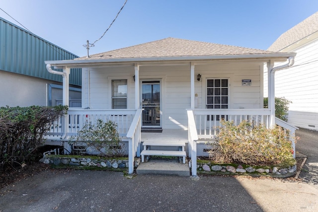 view of exterior entry with a porch