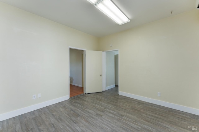 empty room with wood-type flooring