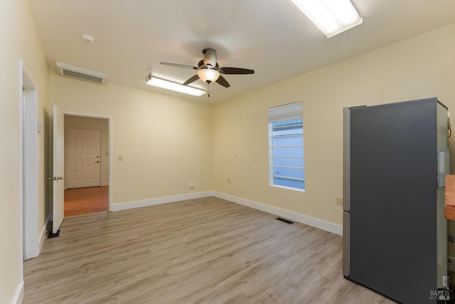 unfurnished room with ceiling fan and light hardwood / wood-style floors