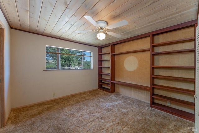 unfurnished bedroom featuring carpet floors, wood ceiling, and crown molding