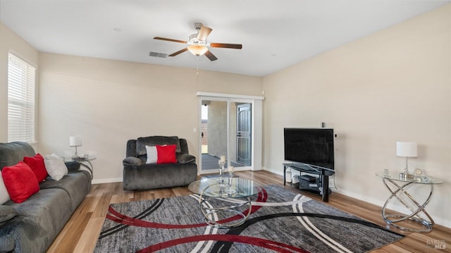 living room featuring ceiling fan and wood-type flooring