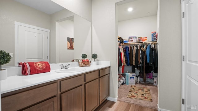 bathroom with hardwood / wood-style floors and vanity