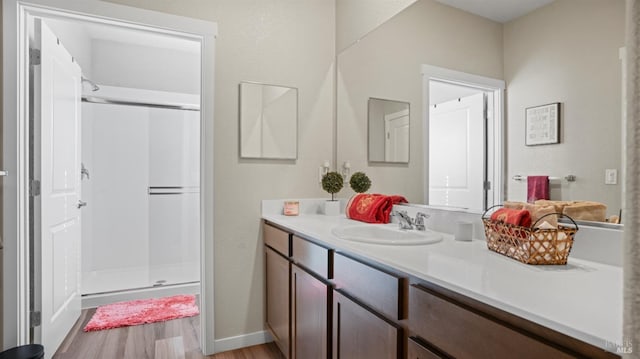 bathroom featuring hardwood / wood-style floors, vanity, and an enclosed shower