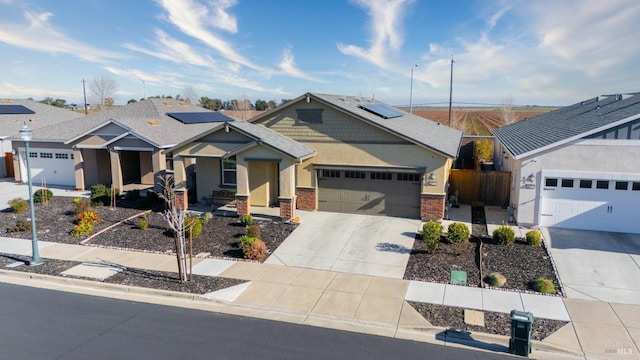 view of front of home with solar panels and a garage