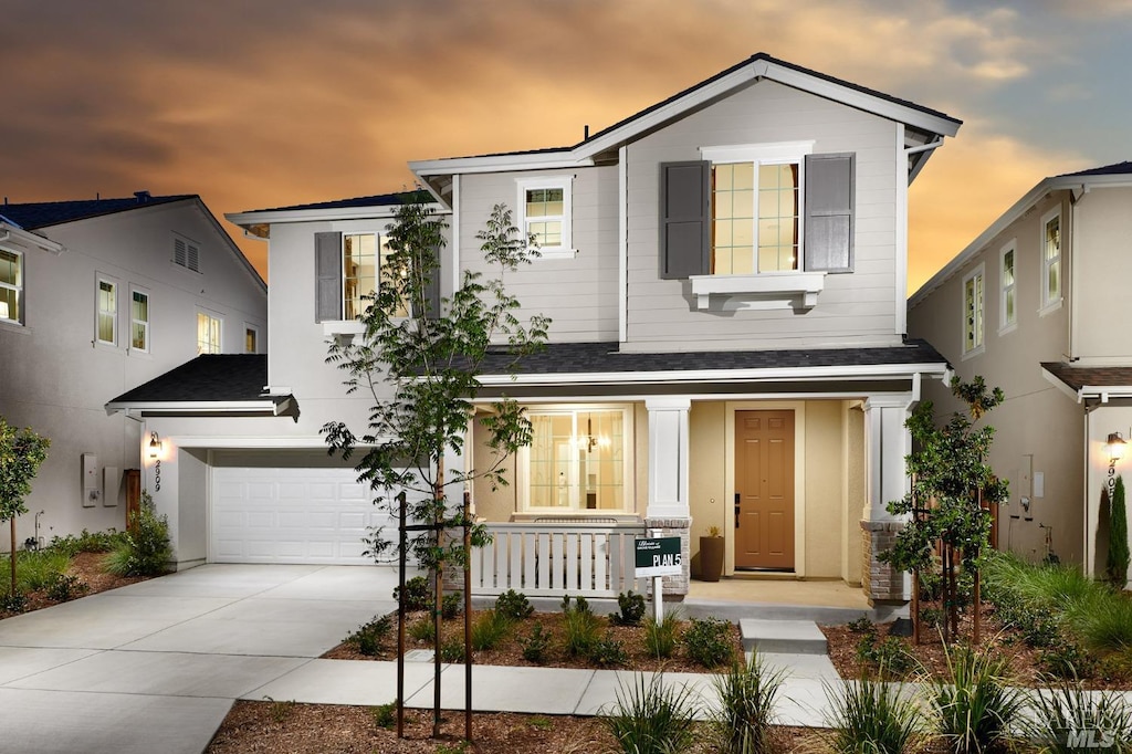 view of front of home featuring a porch and a garage