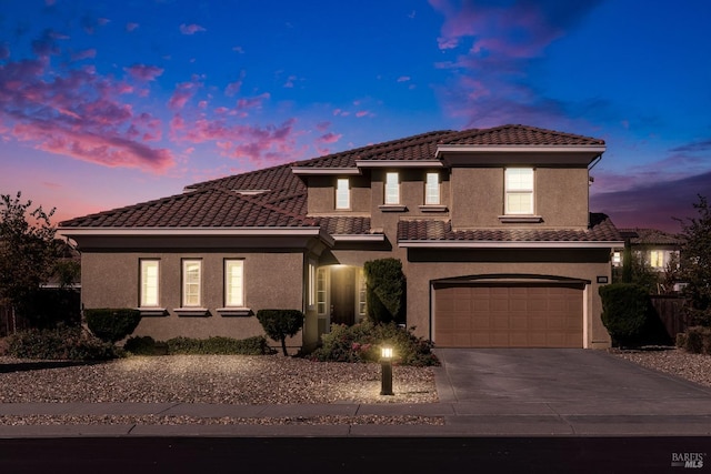 mediterranean / spanish house featuring a garage