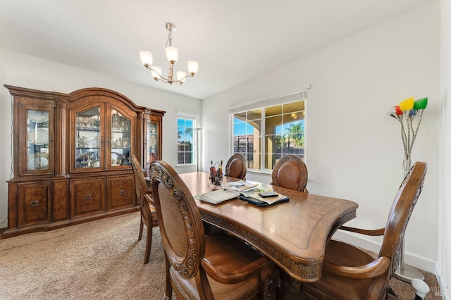 dining area with light carpet and an inviting chandelier