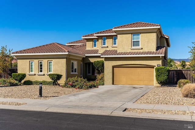 mediterranean / spanish-style home with a garage