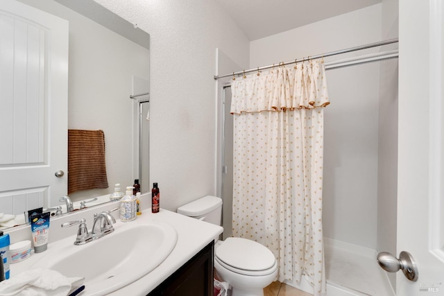 bathroom with a shower with curtain, toilet, and vanity