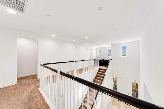 hallway featuring light carpet