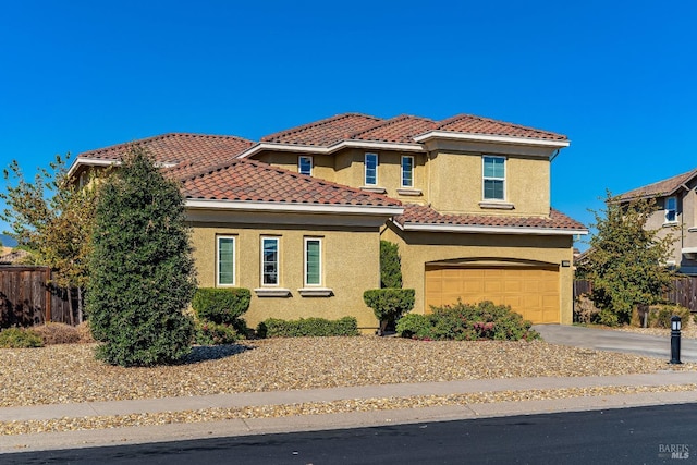 mediterranean / spanish-style home featuring a garage