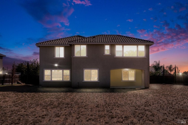 view of back house at dusk