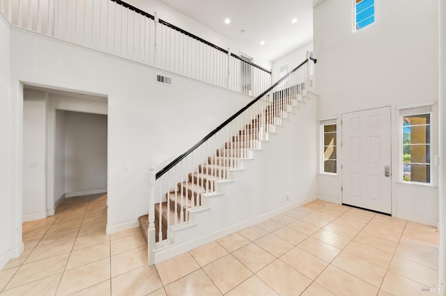 tiled foyer entrance with a high ceiling