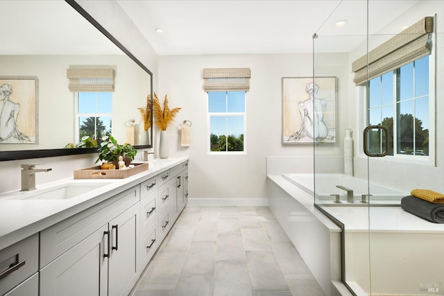 bathroom featuring vanity and shower with separate bathtub