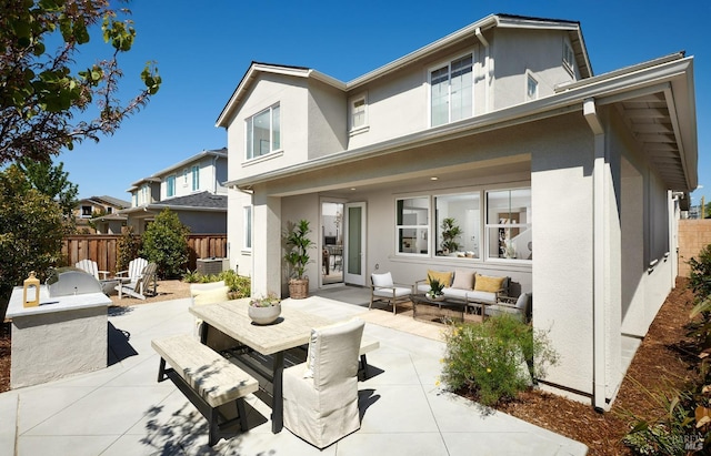 rear view of property featuring a patio area and outdoor lounge area