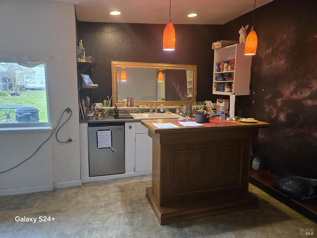 bar featuring decorative light fixtures, dishwasher, and sink