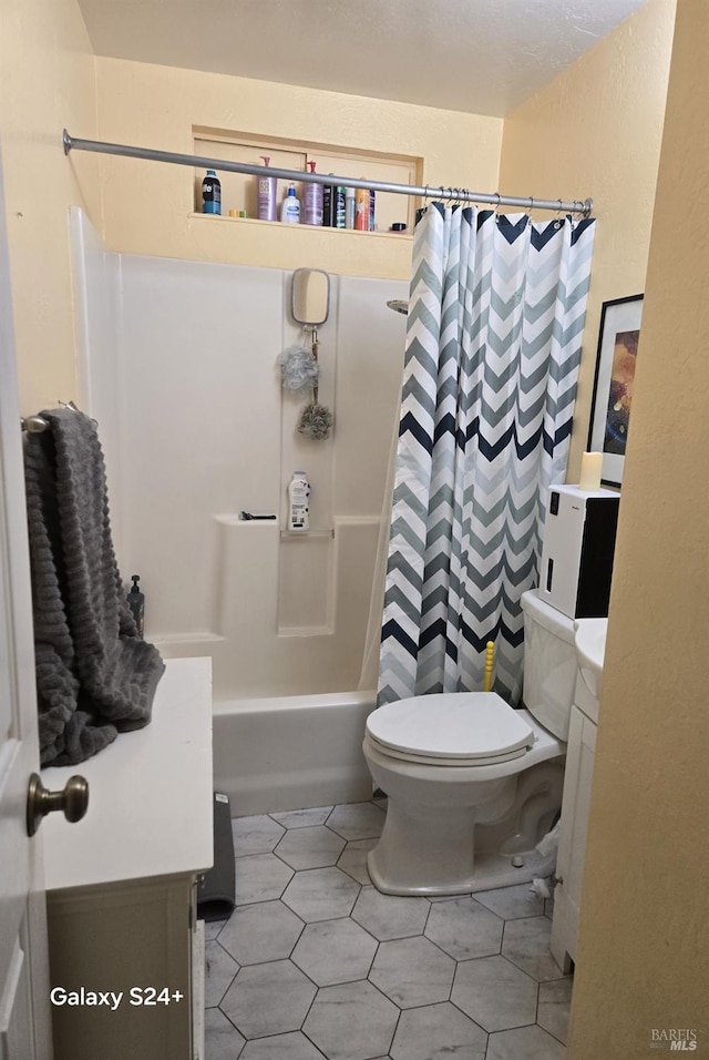 full bathroom with vanity, tile patterned floors, toilet, and shower / bath combo with shower curtain