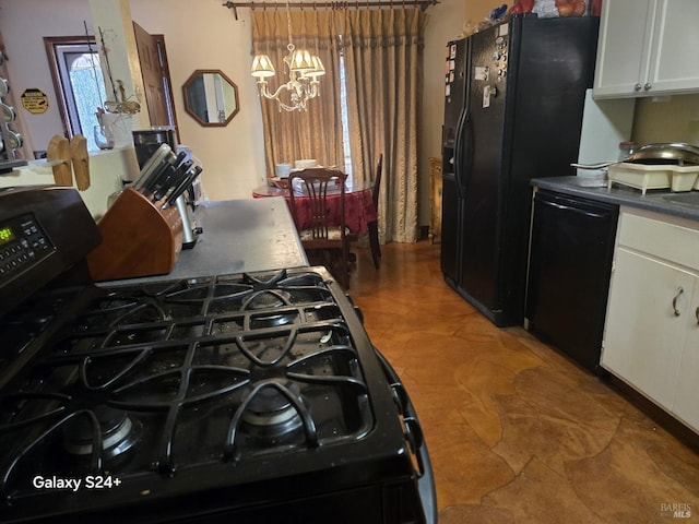 kitchen with white cabinetry, pendant lighting, an inviting chandelier, and black appliances