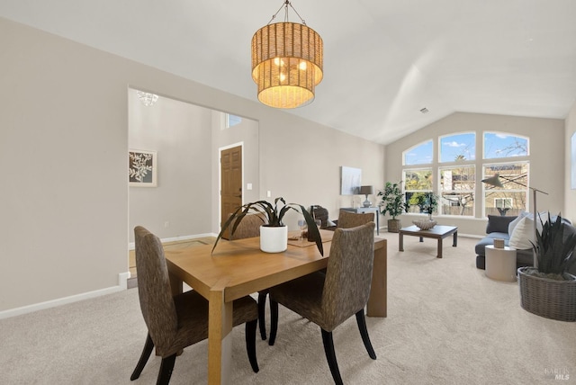 carpeted dining area featuring vaulted ceiling