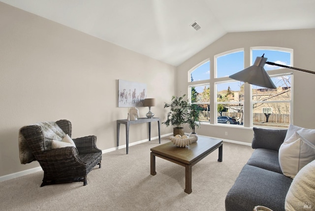 living room featuring light carpet and vaulted ceiling