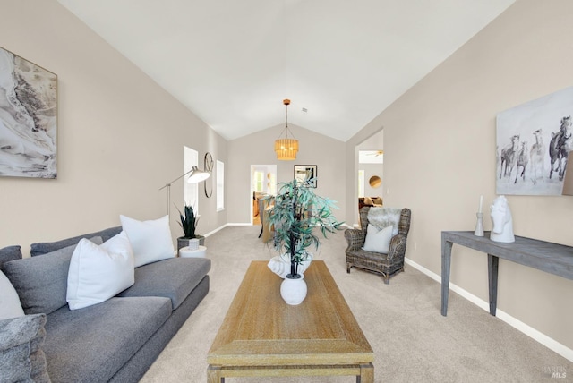 living room featuring vaulted ceiling, light carpet, and a chandelier