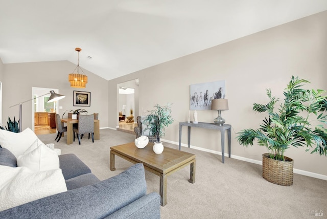 living room with light colored carpet, vaulted ceiling, and a notable chandelier