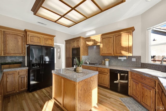 kitchen with hanging light fixtures, sink, and a wealth of natural light