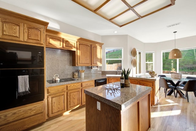 kitchen featuring black appliances and tasteful backsplash