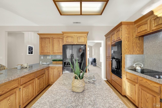 kitchen with black appliances and backsplash