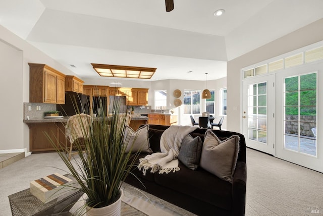 living room with light carpet and ceiling fan