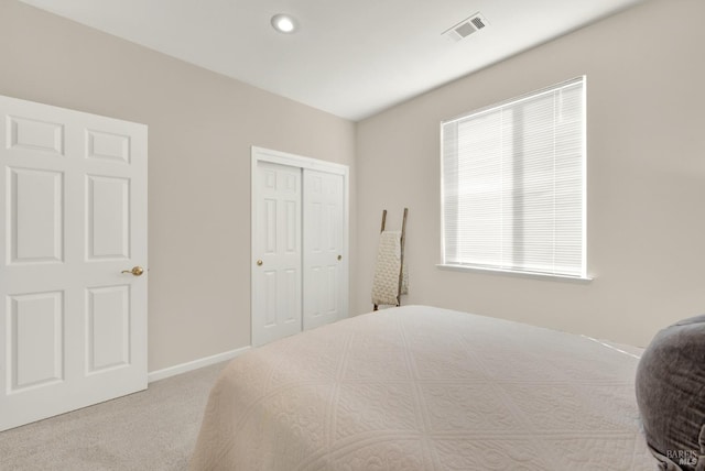 carpeted bedroom with a closet