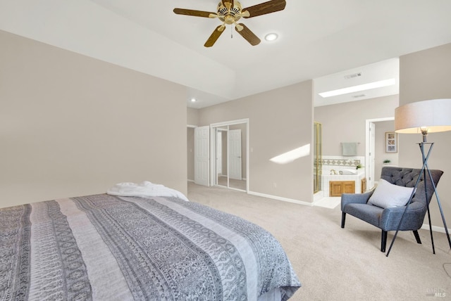 bedroom featuring light carpet, connected bathroom, and ceiling fan