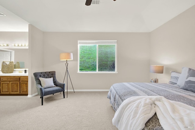 bedroom with ensuite bathroom, ceiling fan, and light carpet