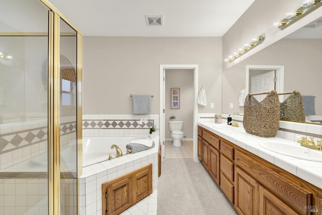 full bathroom featuring tile patterned floors, vanity, toilet, and independent shower and bath