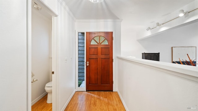 foyer featuring light hardwood / wood-style floors and crown molding