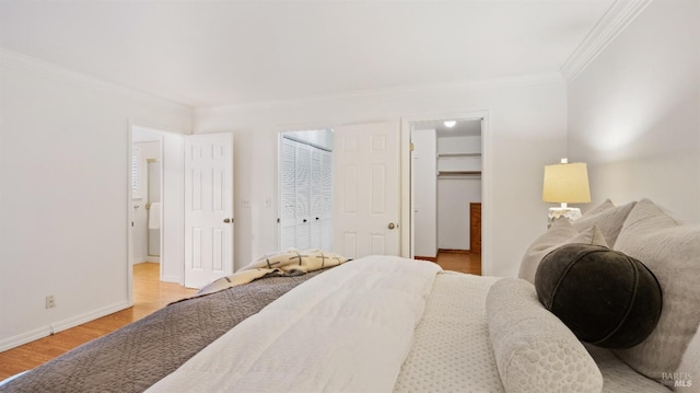 bedroom featuring crown molding and light hardwood / wood-style flooring