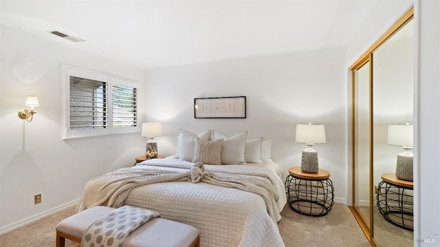 bedroom with a closet and light colored carpet